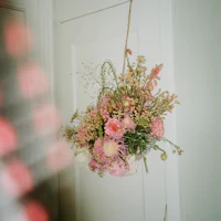a bouquet of flowers hanging on a door